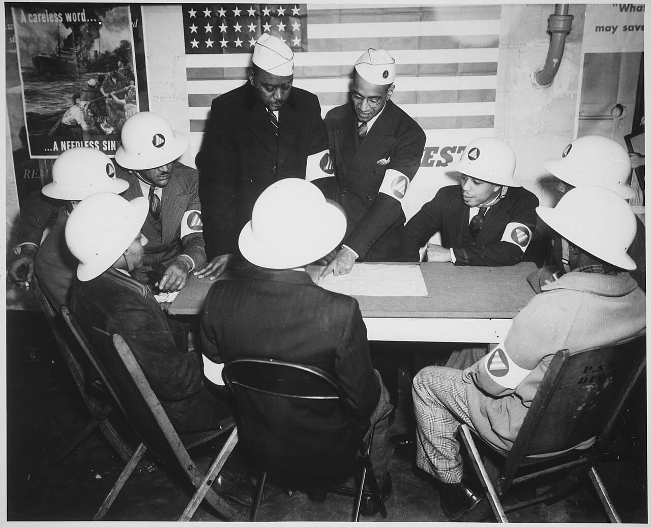 "Air raid wardens at a sector meeting in Washington, DC, discuss the zones they control during a practice air raid.", ca - NARA - 535827
