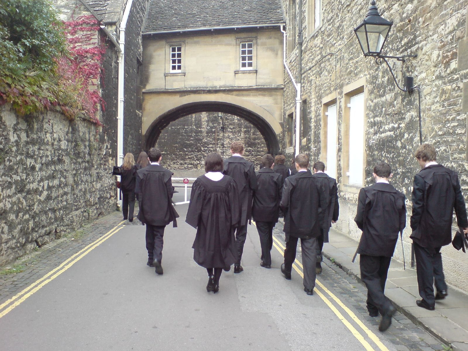 Oxford students in academic dress, gowns short and hoods small.