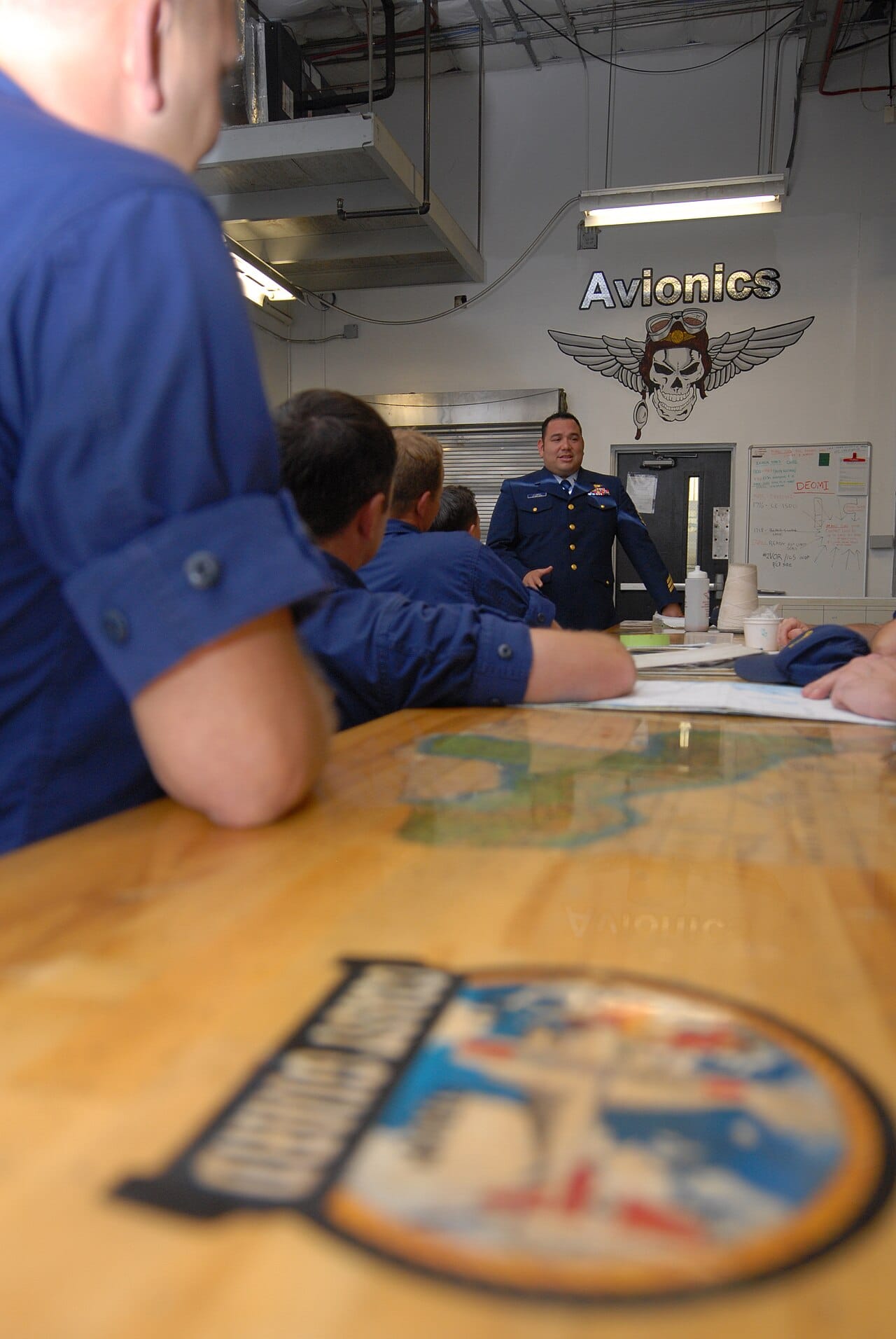 U.S. Coast Guard Chief Petty Officer Paul Llamas, center, an avionics electrical technician at Coast Guard Air Station Clearwater, Fla., speaks to crew members about Sexual Assault Awareness and Prevention Month 130403-G-XD768-018