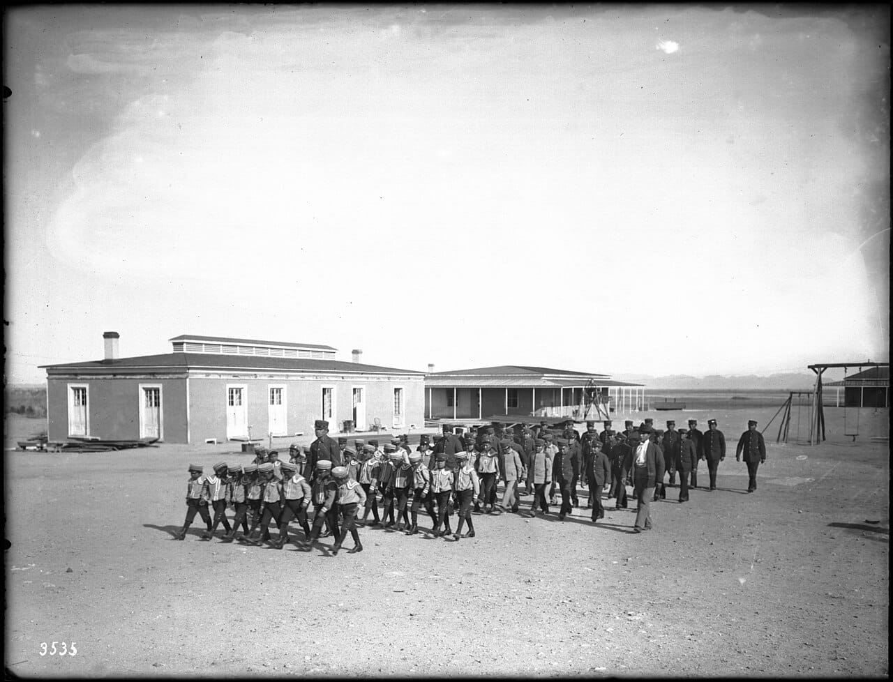 Boys marching in formation outside an Indian boarding school.