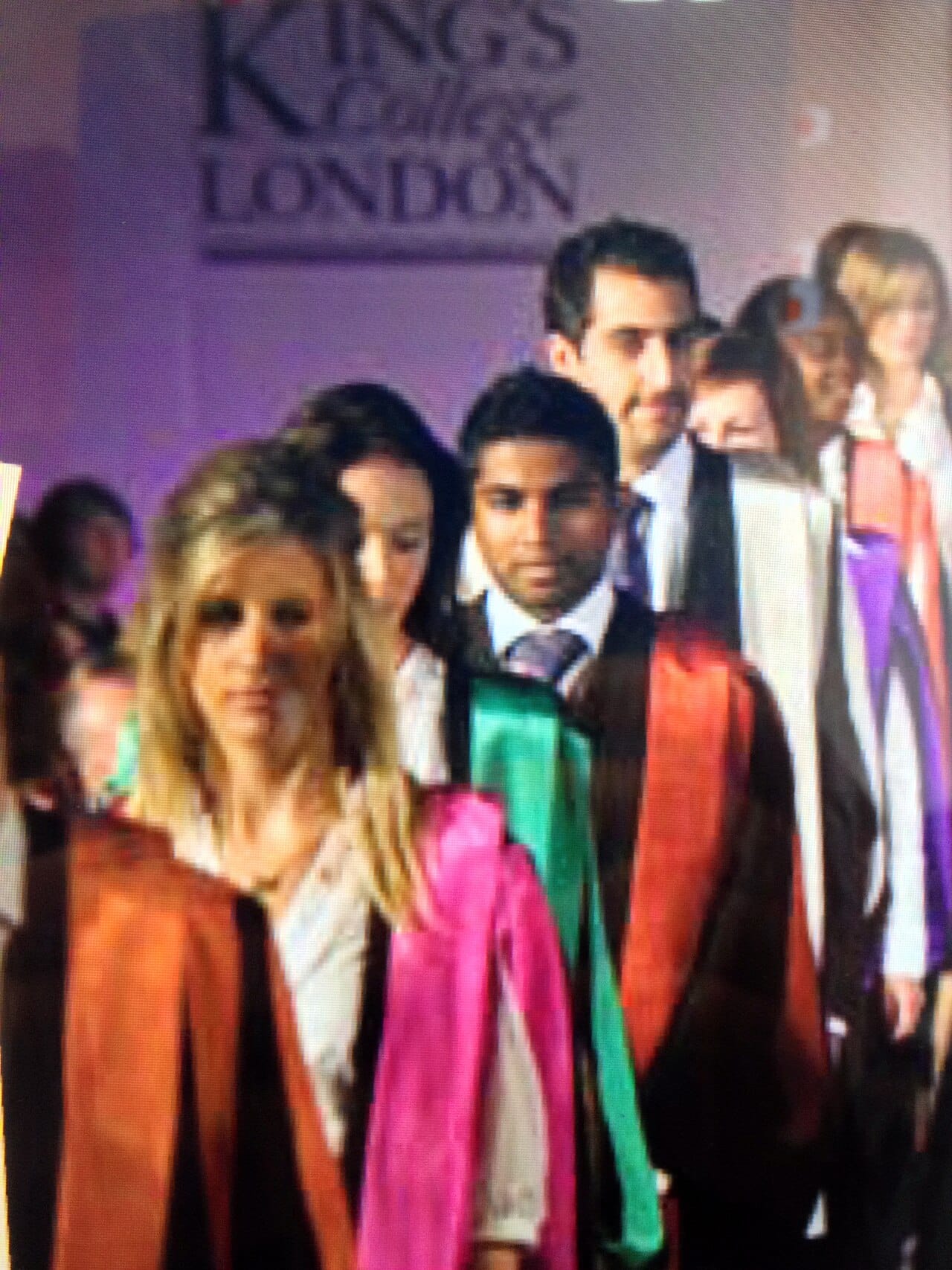 Academic dress at King's College London: gown, hood, and the coloured facing at the neck.