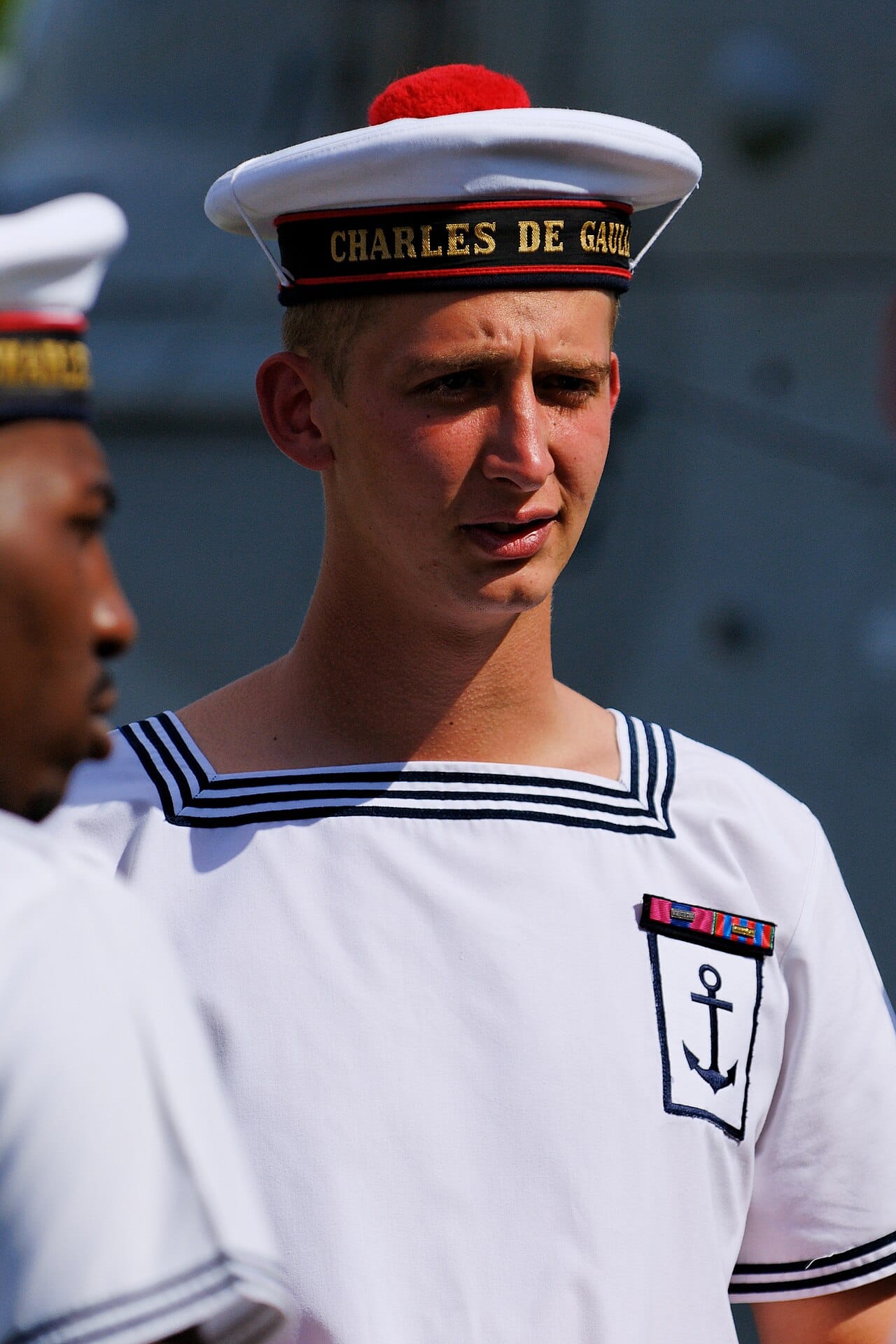 A French seaman in white dress on a national holiday.