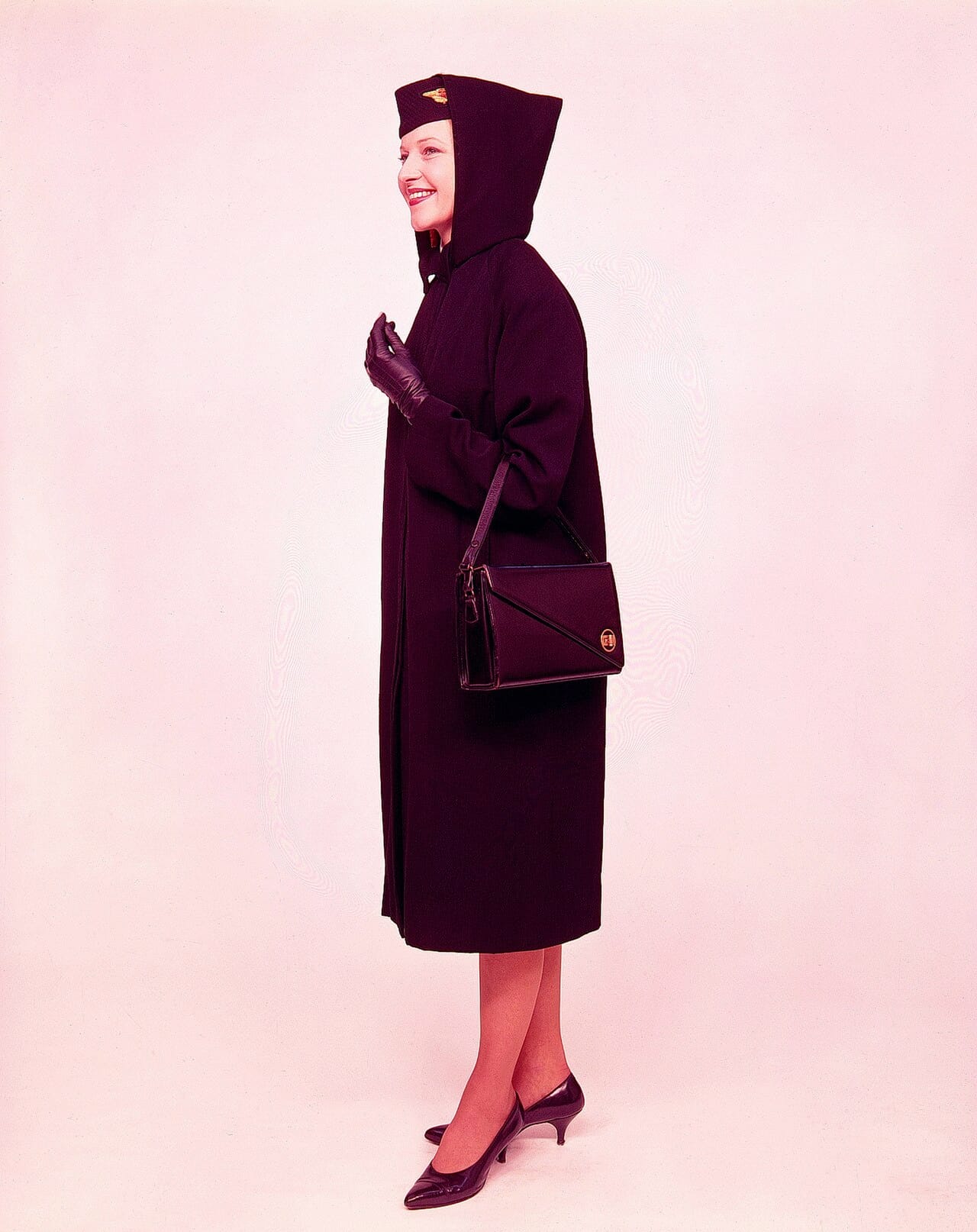 A winter cabin crew uniform of 1959: tailored jacket, matching skirt, cap.