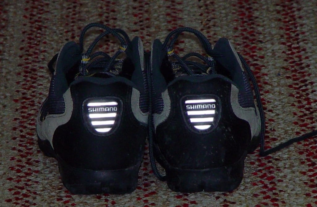 Retroreflective panels on the heels of a pair of cycling shoes.