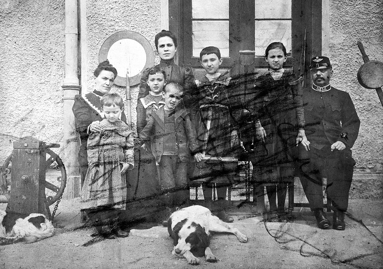 A railway employee photographed with his family, in uniform.