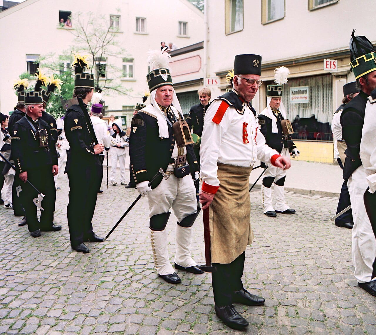A group in the same dress, aprons visible.