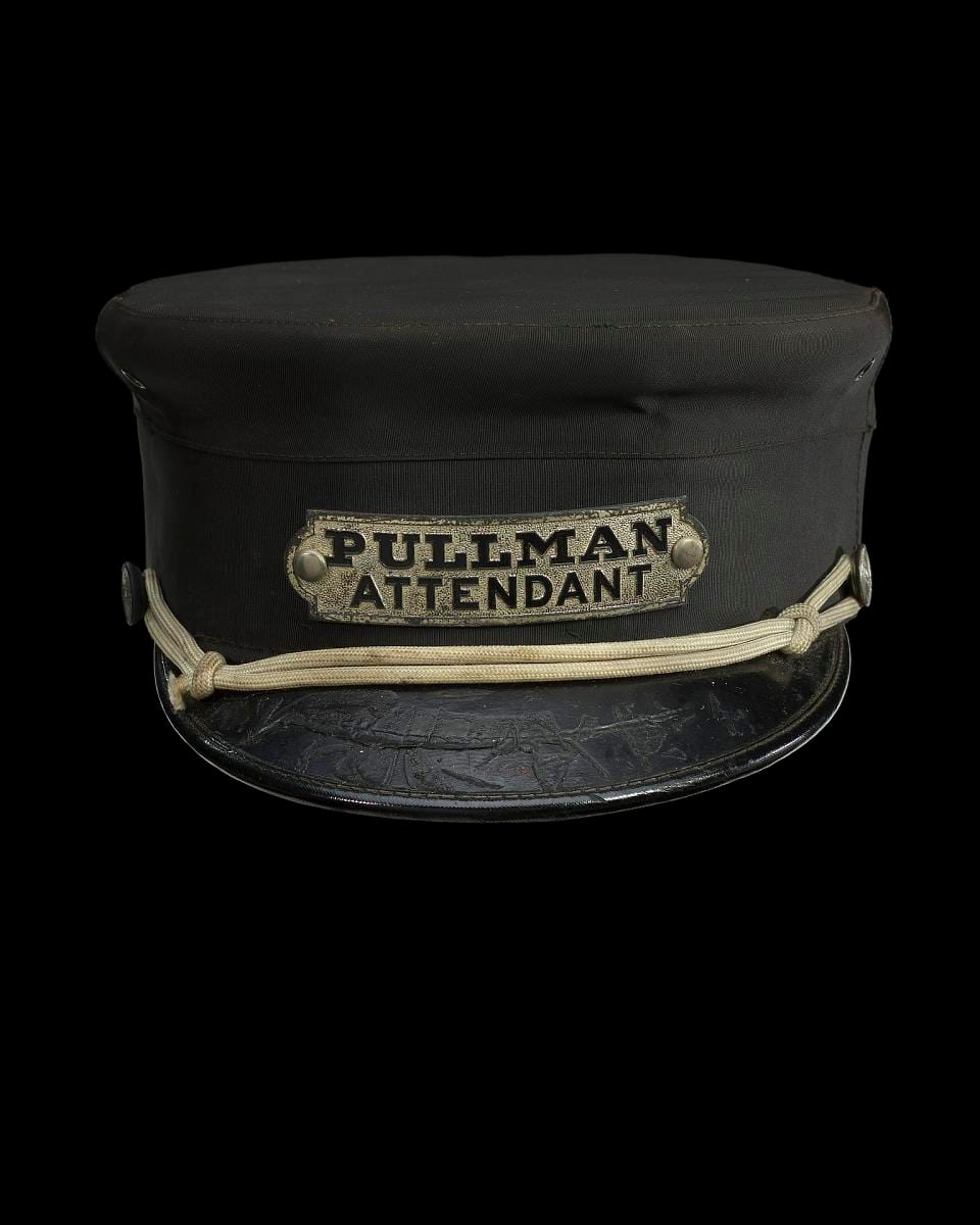 A uniform cap for a Pullman attendant, dark and plain.