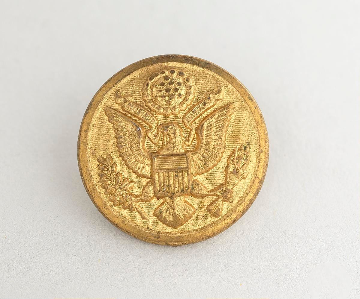 A single button from the Army Nurse Corps uniform of Lt. Louise Lomax, 1943–1953.