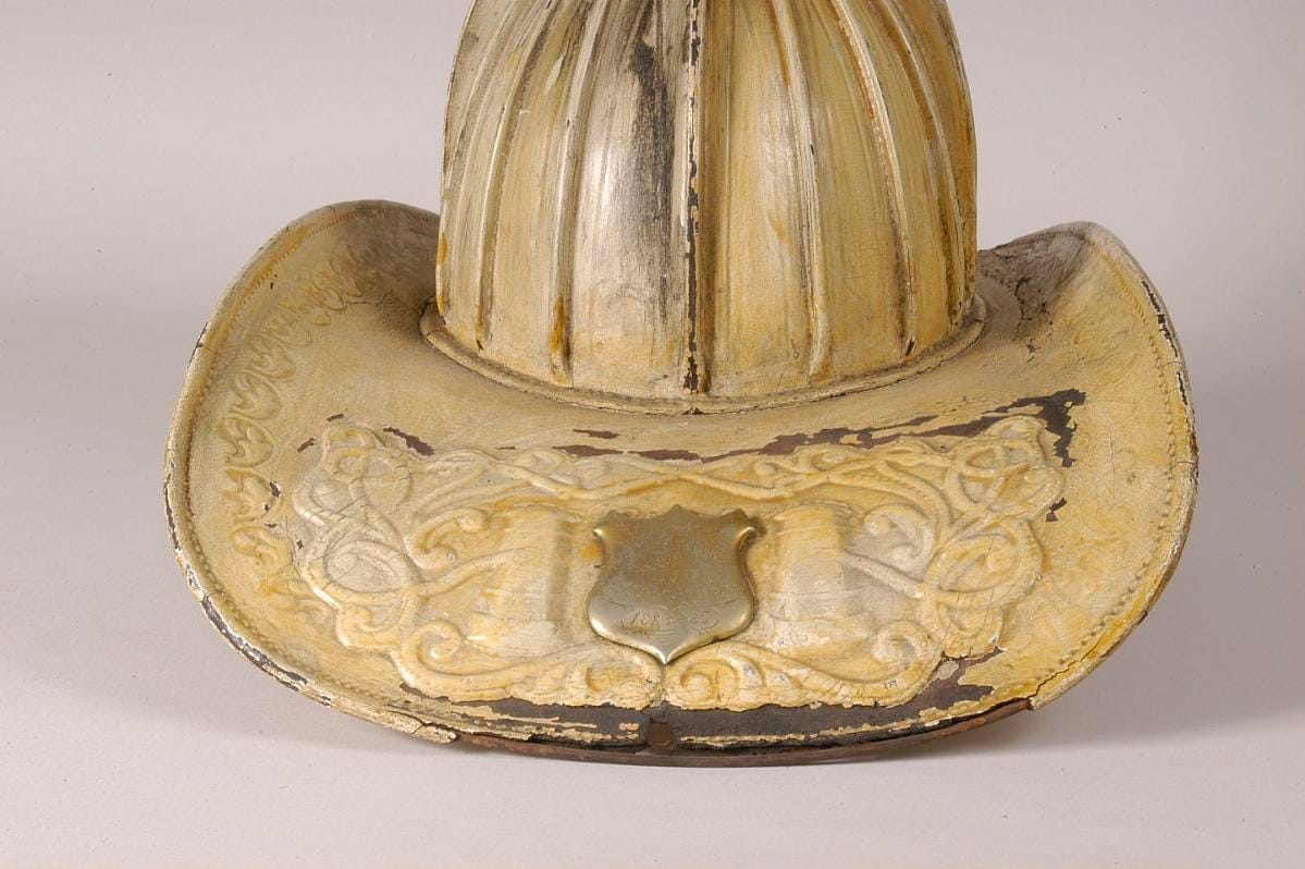 A helmet of markedly plainer construction, its shield small and unlettered.