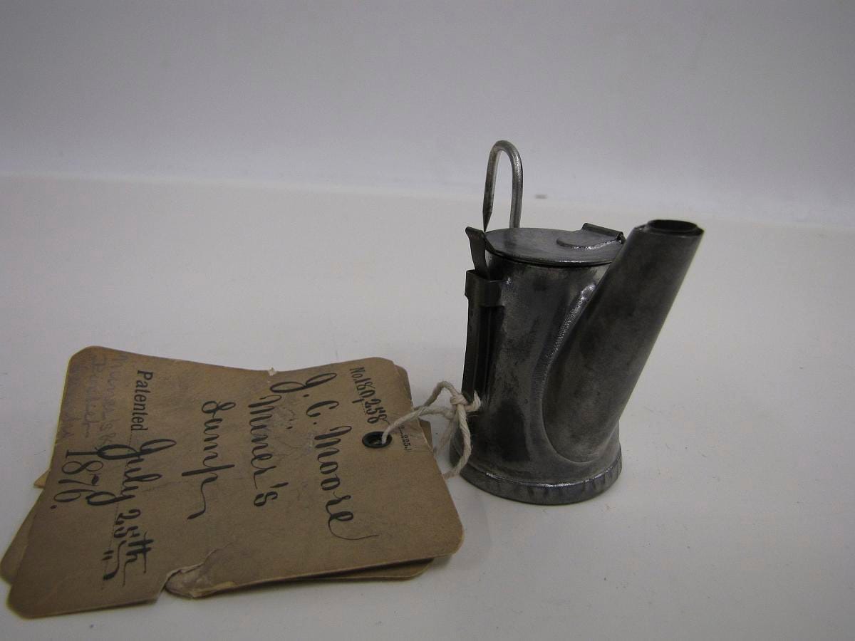 Another patent model from the same series, differing in the hook and the spout.