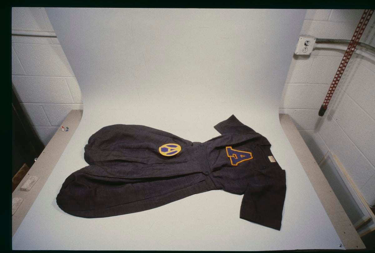 The same gym suit seen flat, the name of the school marked on it.